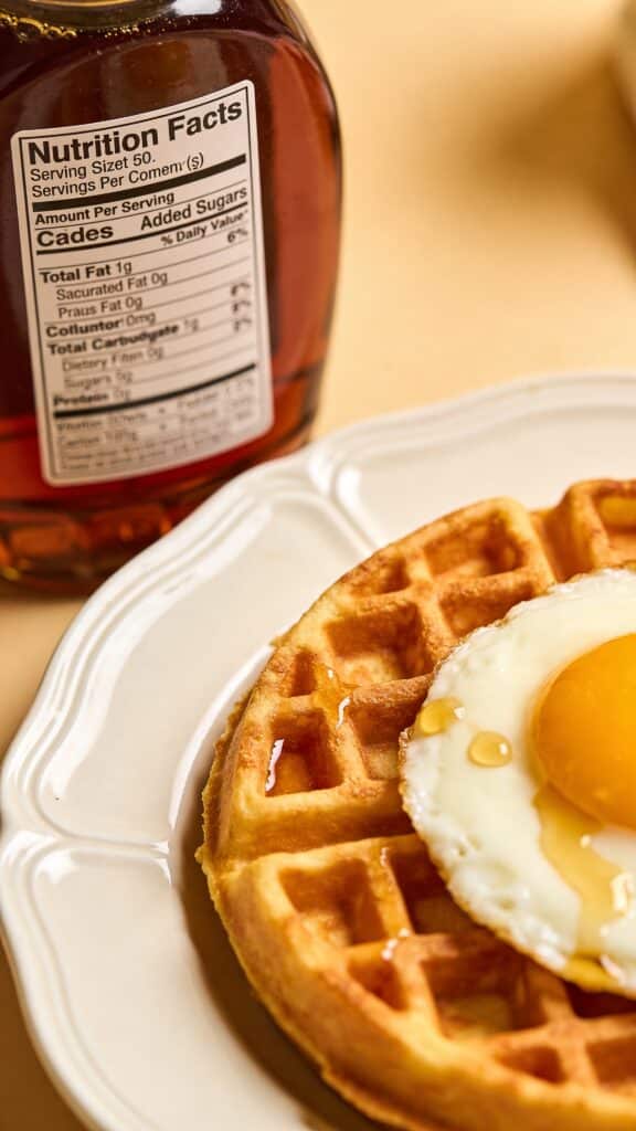 Work-in-Progress photo instruction:
Photograph a nutrition label close-up on a syrup bottle, with “Added Sugars” visible, next to a plated chaffle.