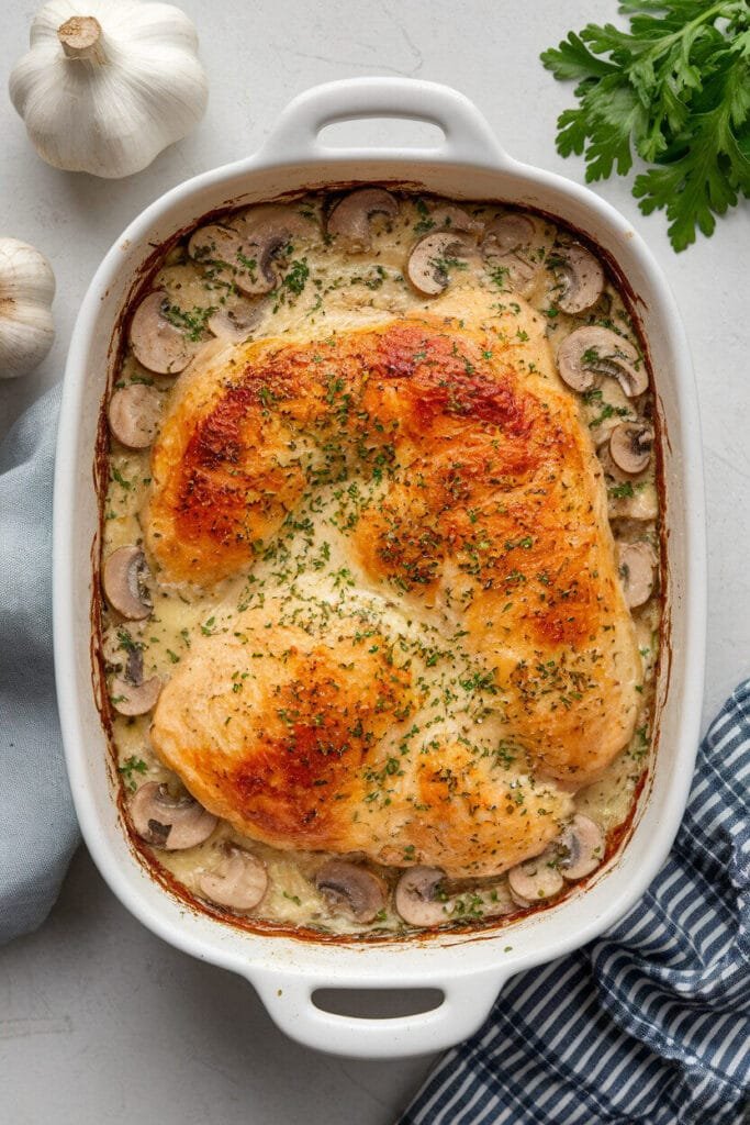 Creamy Keto Garlic Mushroom Chicken Casserole with golden cheese crust and herb garnish